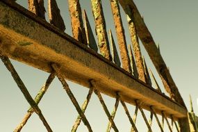 fragment of rusty Metal fence at sky