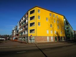 bright yellow facade of a corner house