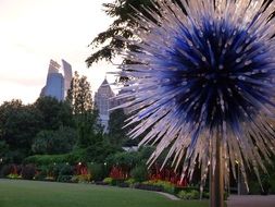glass flower on a background of city panorama