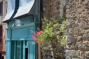 beautiful old house Facade with flowers on stone wall, france, brittany