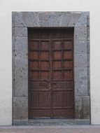 brown wooden door in a stone building