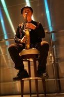 Musician is playing with the saxophone