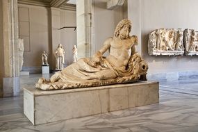 ancient sculpture of a lying man