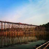 wooden Bridge across calm River, thailand, kanchanaburi