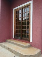sliding doors and pink building facade
