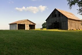 wooden sheds among farmland