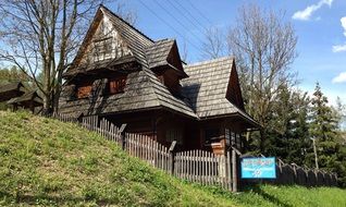 old wooden fenced house on hill side, Poland