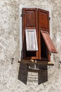 building facade with beautiful wooden shutters on a sunny day