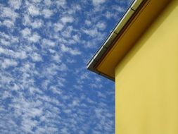 facade of a building against a blue cloudy sky