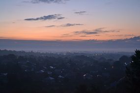 pink dawn and fog over the village