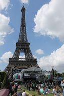 people on the green grass near the eiffel tower, france, paris
