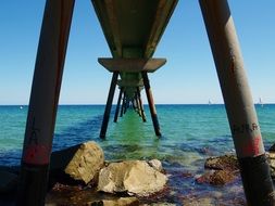 stones in the sea under the bridge