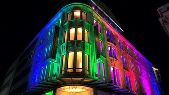 multi-colored night illumination on the facade of the building