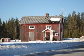 abandoned wooden house at winter forest