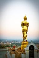 golden buddha statue over the city