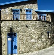 stone house with blue door and shutters