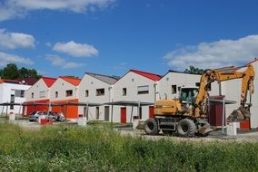 excavator near the houses in the village