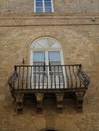 medieval building facade with balcony in volterra