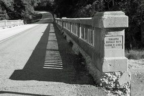 black and white photo of stone bridge in America