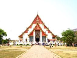 people near buddhist temple in thailand
