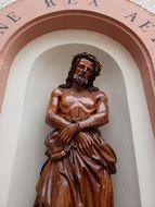 statue of jesus on the facade of the building