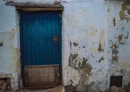 blue door and white wall in an old building