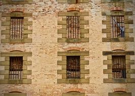 sandstone building with barred windows