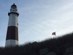 american flag near lighthouse