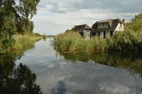 house on the green bank of the river