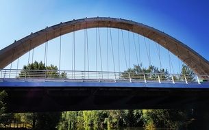 bridge with arched railing on a background of blue sky