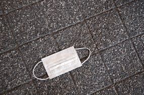 respiratory mask on the pavement in Tokyo