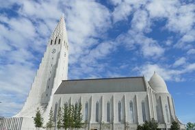 Beautiful church in Reykjavik at blue sky background with white clouds