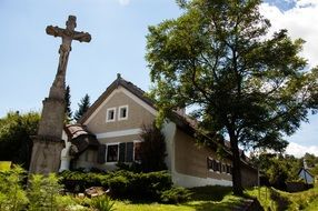 old stone crucifixion at house in summer Countryside landscape, hungary