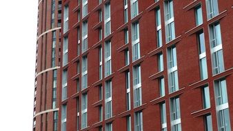 geometric building facade with red bricks and windows