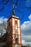 bell tower behind a tree