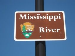 sign on the bridge with the name of the river