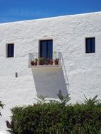 white building with balcony in Ibiza