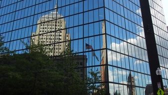 mirror image of a building in a glass facade in boston