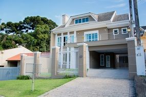 open gateway to two-storey mansion in countryside