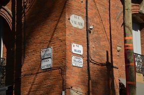 brick wall of a city building with numbering