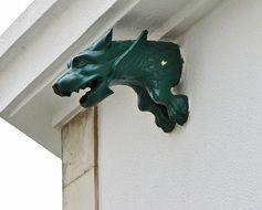 green chimera on a building wall