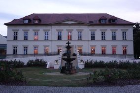 fountain in front of a beautiful castle