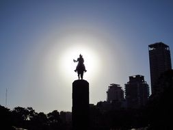 silhouette of a monument in buenos aires in the rays of the bright sun