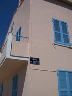 pink facade with blue shutters on windows, France, Corsica