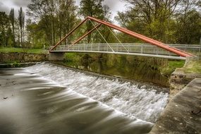 bridge over the river in the park on a cloudy day