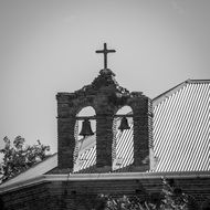 black and white photo of the roof with a cross on the church