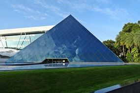 glass pyramid near green trees