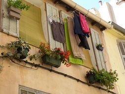 builing facade with flower boxes and clothes line in Marseille