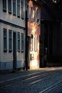 rays of sunlight on a dark city street