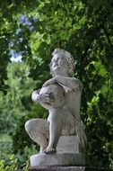sculpture of a boy with a ball in the park
